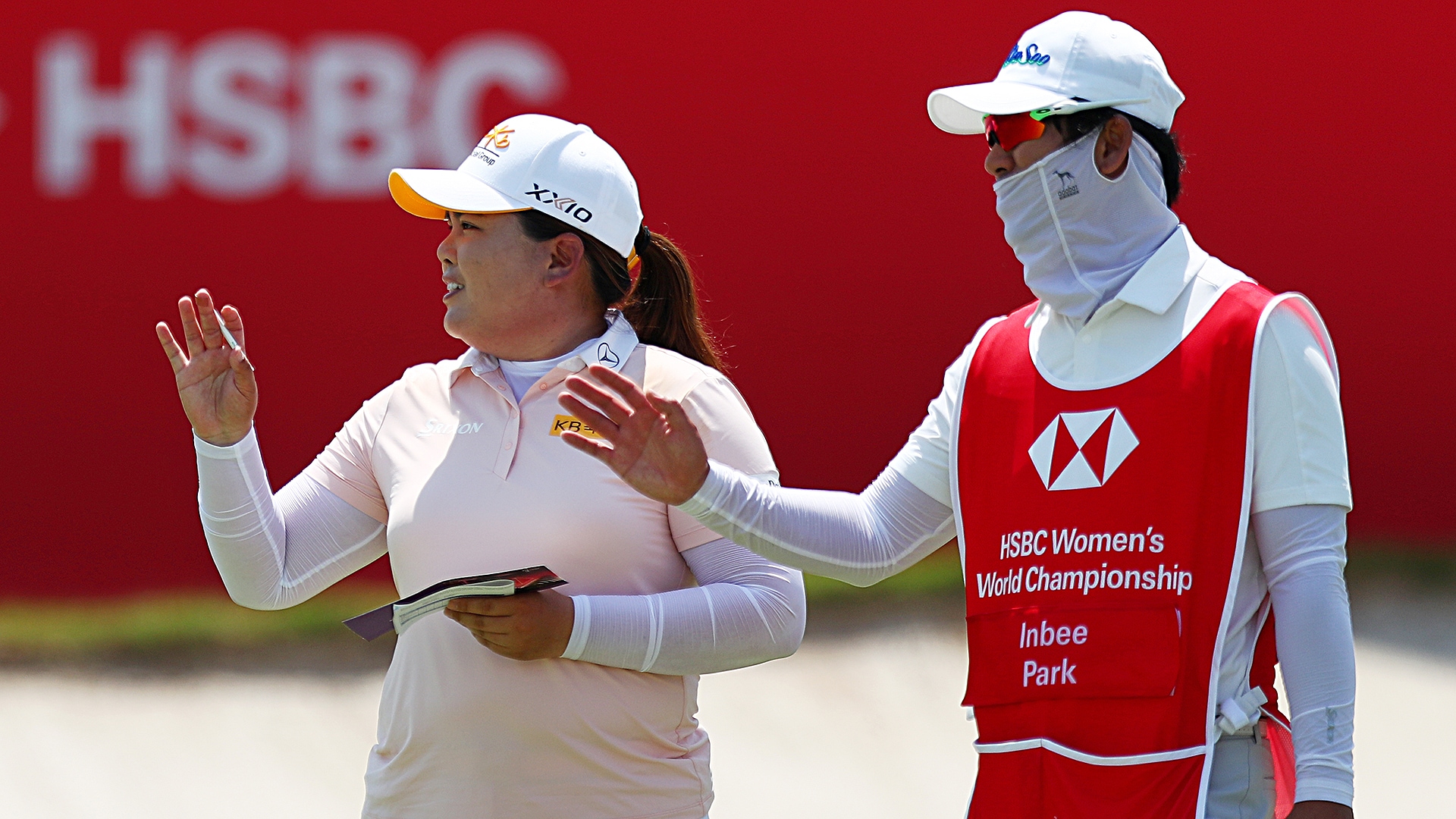 With husband filling in as caddie, Inbee Park shoots 64 to lead in Singapore