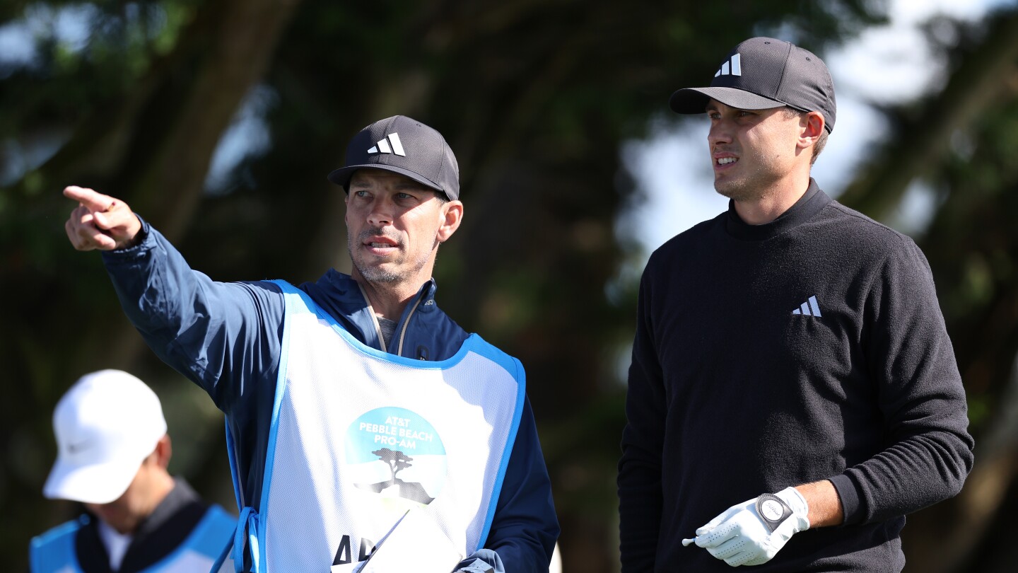 Pebble co-leader Åberg and caddie working on their math