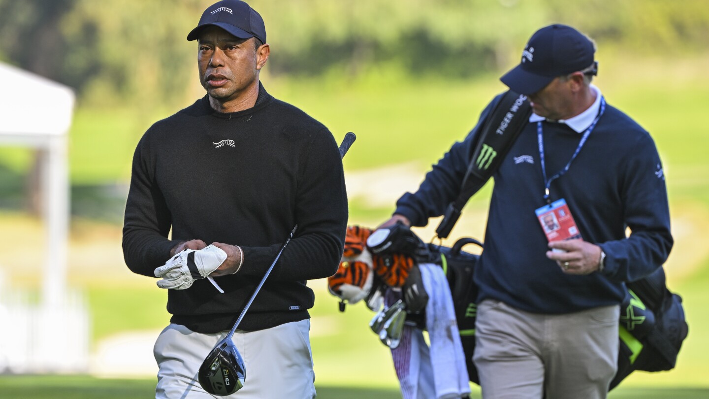 In new Sun Day Red gear, Tiger plays quick 9 on Tuesday
