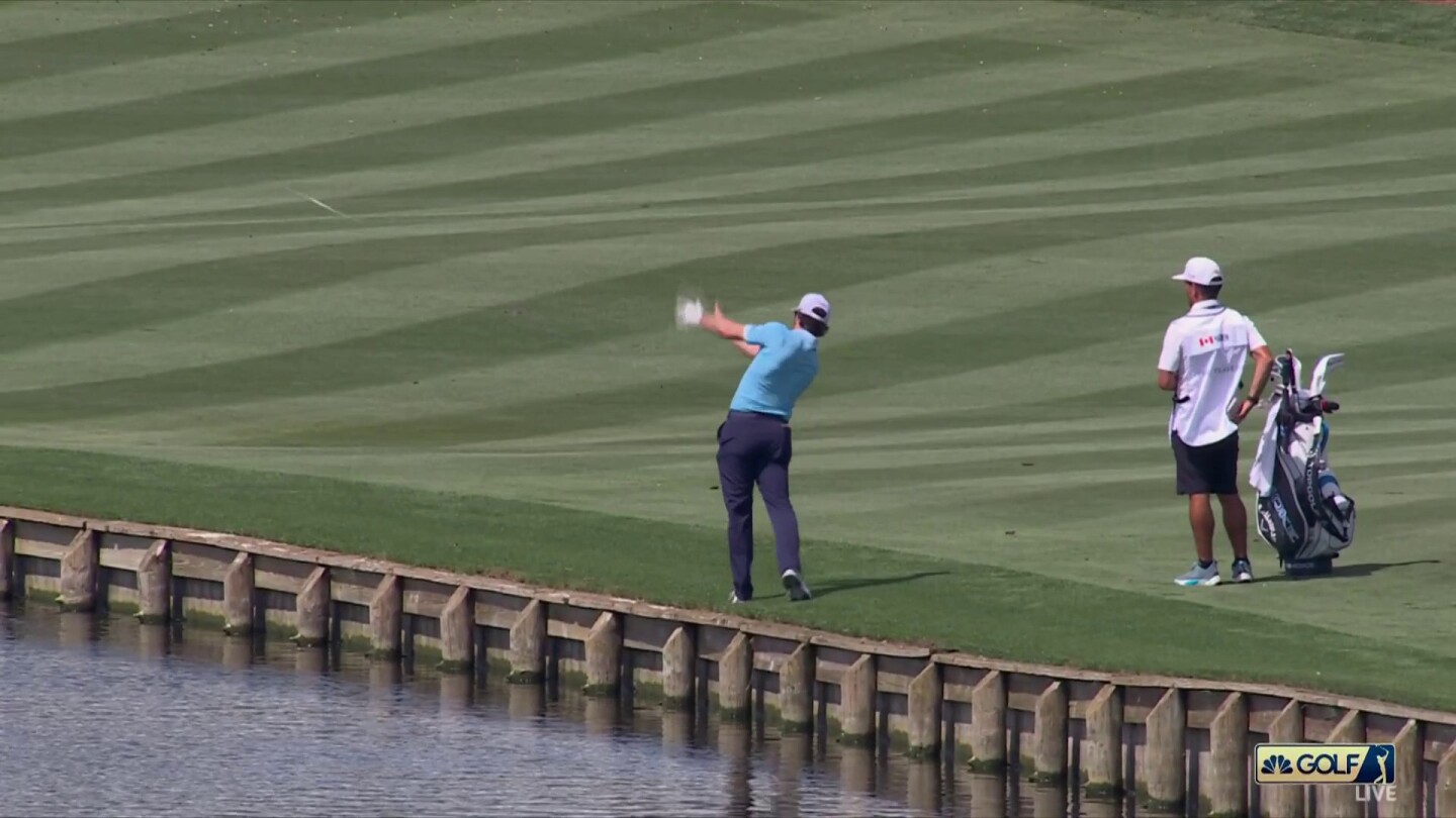Adam Hadwin tosses his club in the lake after finding water at The Players