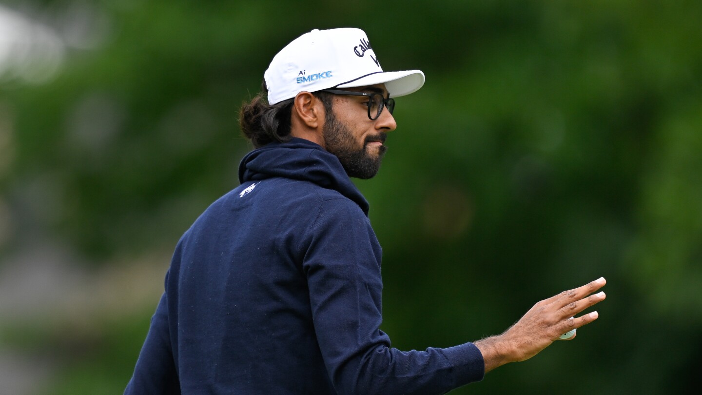 Akshay Bhatia shares lead in Detroit after golf ball finds fairway drain on 17th